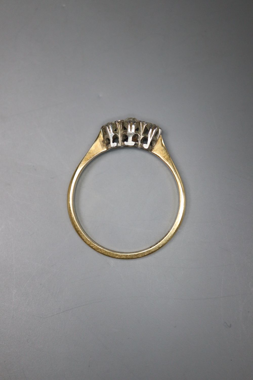 An 18ct & Pt, three stone diamond ring, size M/N, gross 1.8 grams.